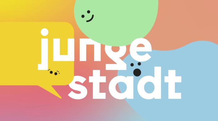 Eine bunte Illustration mit bunten Blobfiguren und in der Mitte der Titel Junge Stadt.